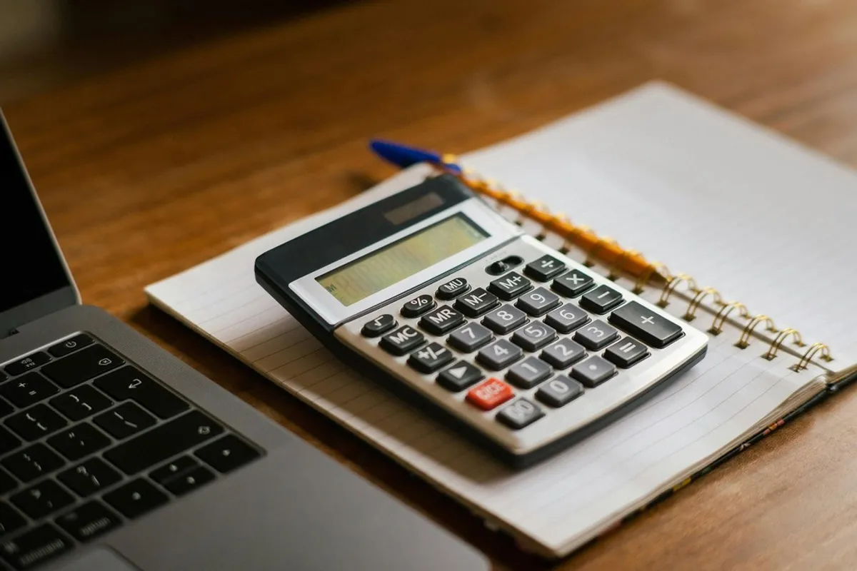A person working through loan paperwork on a laptop